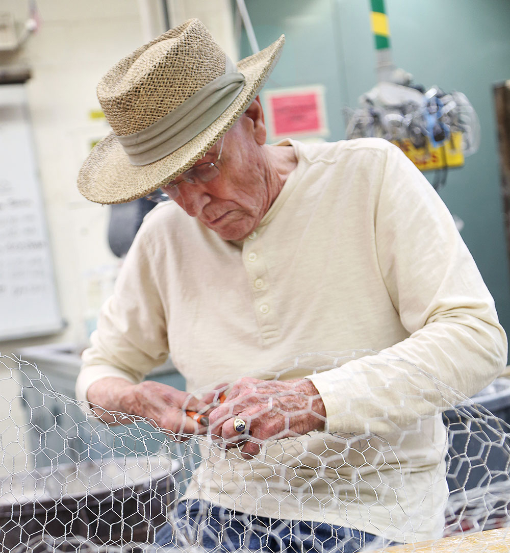 An older adult takes an art class in the noncredit division.