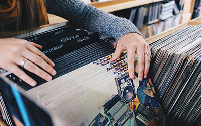 Woman flipping through Vinyl Records.